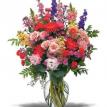 Colorful seasonal flower mixture in simple glass vase